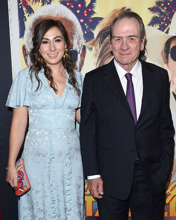 Tommy Lee Jones and his daughter Victoria posing together at a formal event with a colorful backdrop.