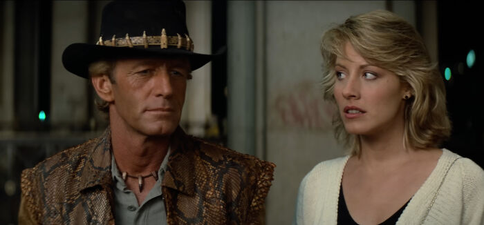 Man in a cowboy hat and snakeskin jacket with a woman in a white sweater, illustrating lesser-known facts about these countries.