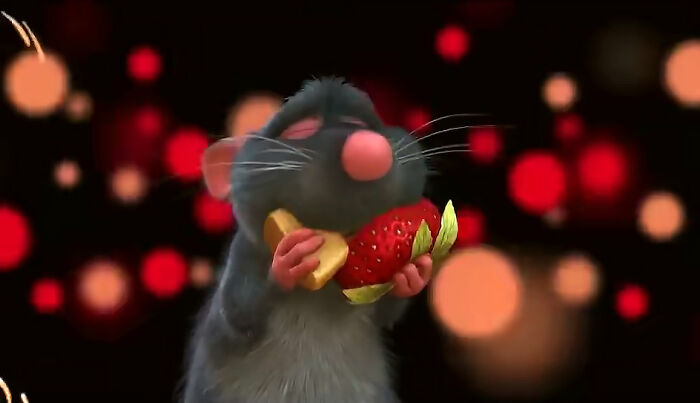 Animated rat character holding a strawberry and cheese, representing moments that hit people harder than expected.
