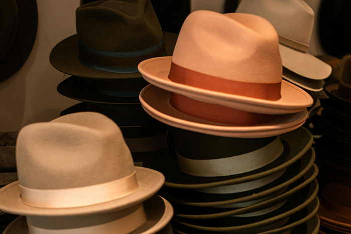 Stacked beige and brown hats in a store, illustrating unique quirks that ended attraction moments for 108 women.