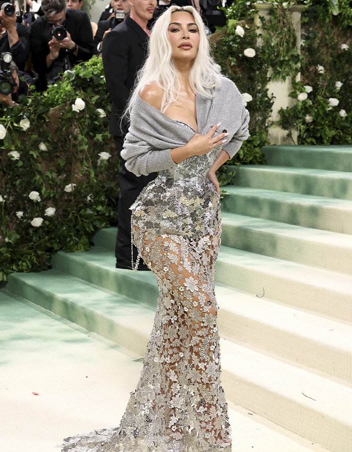 Woman wearing a sheer floral gown at an event, highlighting trends in donated lifeless bodies for BBLs and breast implants. Woman wearing a sheer floral gown at an event, highlighting trends in donated lifeless bodies for BBLs and breast implants.
