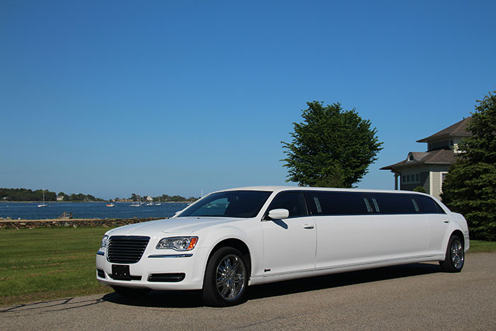 White stretch limousine parked by waterfront near house, capturing a weird scene people still can't explain.