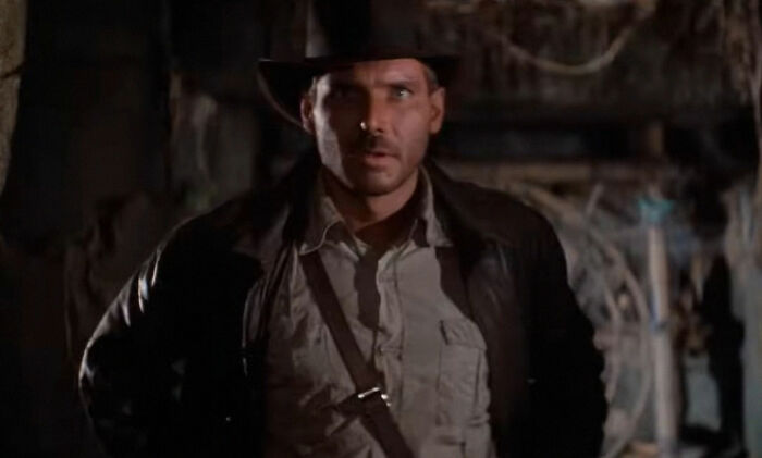 Man wearing a brown hat and jacket in a dimly lit, mysterious setting, evoking moments of weird unexplained events.