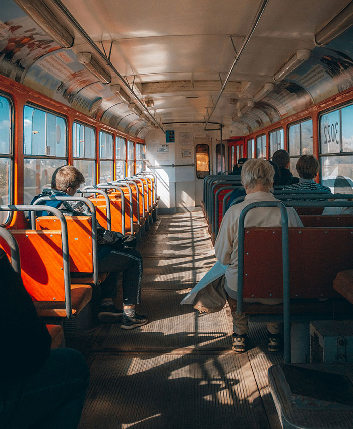 Passengers seated inside an old train with sunlight casting shadows, capturing a weird moment people still can't explain.