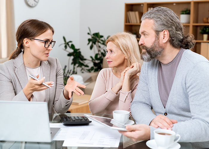 Woman discussing new career choices with friends, refusing to risk it by giving free advice at a table meeting.
