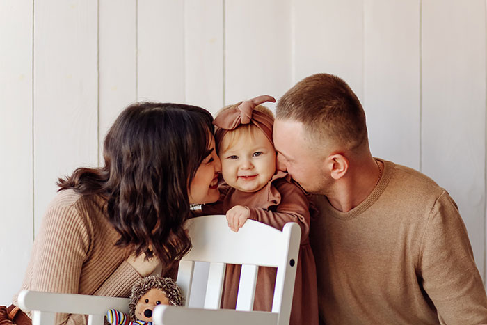 Happy family moment with parents and baby, highlighting relationships and dynamics involving SIL's hubby and partner issues.