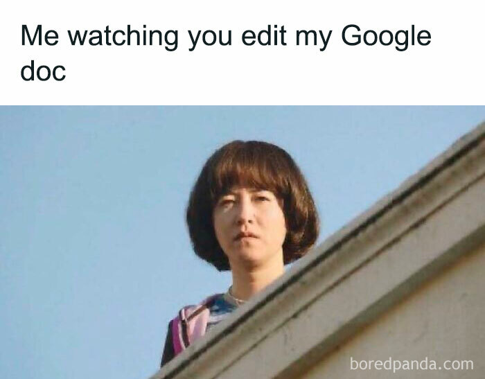 Person with serious expression watching over a rooftop, representing work memes that might make you laugh or cry.