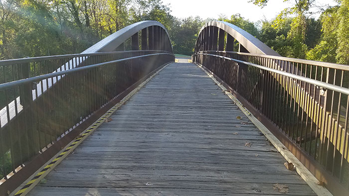 Wooden pedestrian bridge in a natural setting symbolizing lucky times people got out of dangerous situations.