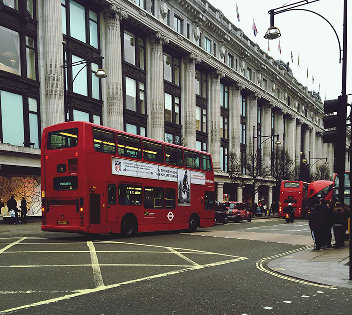 Red double-decker bus on busy city street, illustrating lucky times people escaped dangerous situations.
