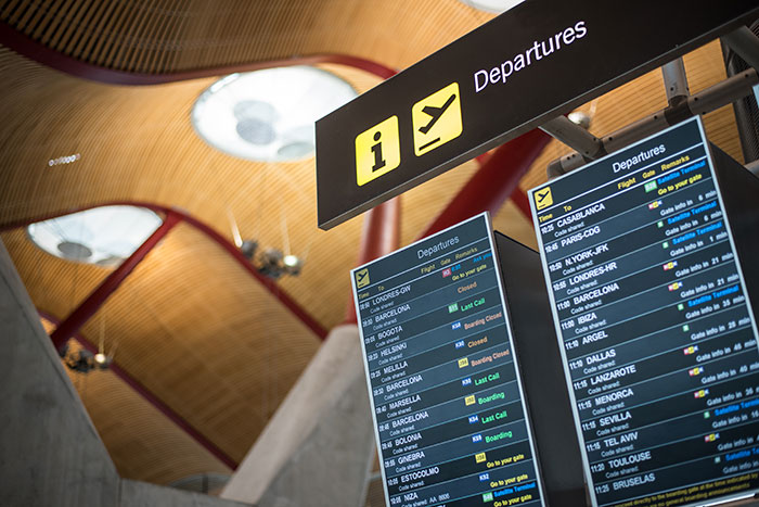 Airport departures board showing flight status with focus on lucky times people got out of last situations.