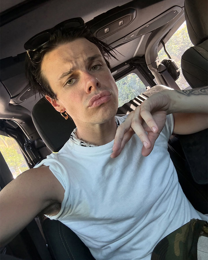 Rock star Yungblud wearing a white sleeveless shirt, taking a selfie inside a car before a wild Sydney yacht party. Rock star Yungblud wearing a white sleeveless shirt, taking a selfie inside a car before a wild Sydney yacht party.