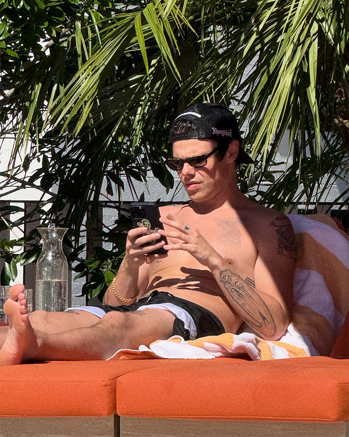 Yungblud shirtless, wearing sunglasses and a cap, lounging and using phone at wild Sydney yacht party. Yungblud shirtless, wearing sunglasses and a cap, lounging and using phone at wild Sydney yacht party.