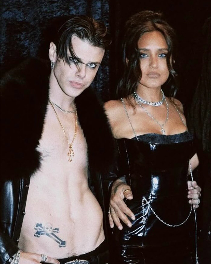 Unclothed rock star Yungblud posing with a woman dressed in black at a wild Sydney yacht party event. Unclothed rock star Yungblud posing with a woman dressed in black at a wild Sydney yacht party event.