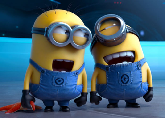 Two Minions in blue overalls laughing together in a brightly lit animated environment, linked to Olympic figure skater music controversy.