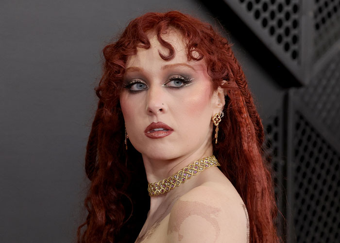 Chappell Roan with dramatic makeup and red hair styled, highlighting her look at the controversial Grammys dress event.