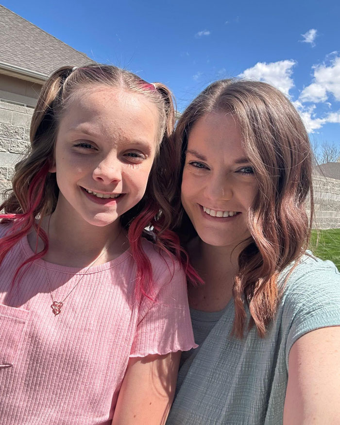 Utah dance mom and daughter smiling outdoors on a sunny day amid parent clash and Vegas tragedy discussion.