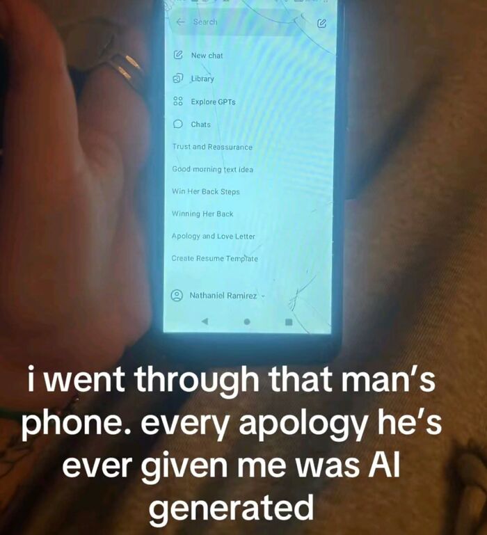 Hand holding a c*****d phone screen showing AI apology templates, reflecting humor and cynicism in relationships.