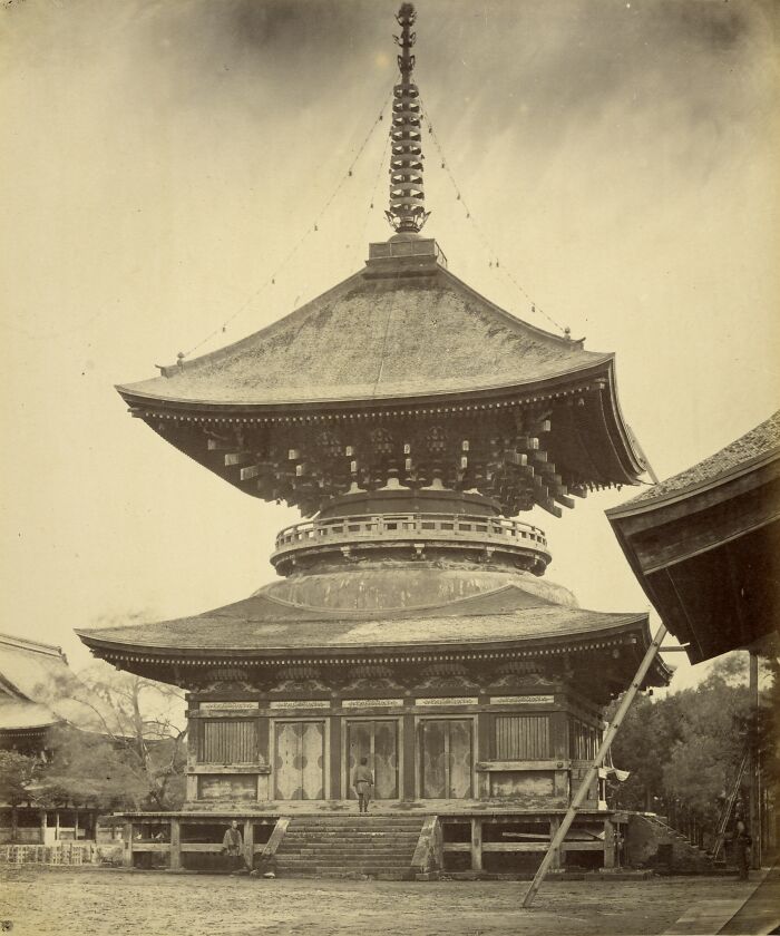 Historic pagoda style building representing interesting buildings lost as the world changed in old sepia photo.