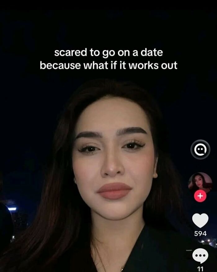 Young woman with a neutral expression sharing a cynical meme about dating fears in a hilarious meme style.