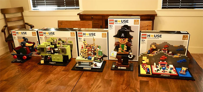 Expensive Lego sets displayed on a wooden table, highlighting stolen items linked to cheating ex-wife's boyfriend arrest.