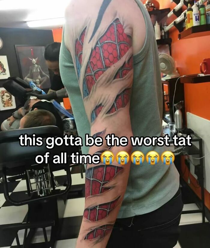 Arm tattoo of a red and blue spider web pattern with ripped skin effect, featured in random memes entertaining and unhinged.
