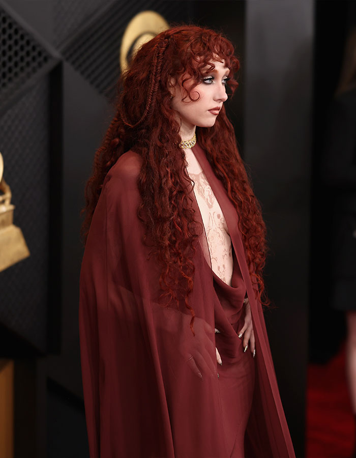 Chappell Roan in a sheer maroon outfit with long curly red hair at the Grammys sparking outrage online.