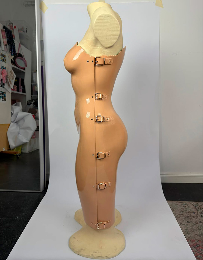 A side view of Heidi Klum controversial Grammys dress design featuring a sculpted form with buckles.