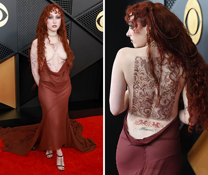 Chappell Roan in a bold brown backless gown showcasing intricate tattoos at a red carpet event with a dramatic train.