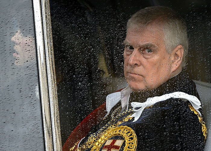 Ex-Prince Andrew seen through rain-covered window amid shocking allegations involving exotic dancer and Epstein case.