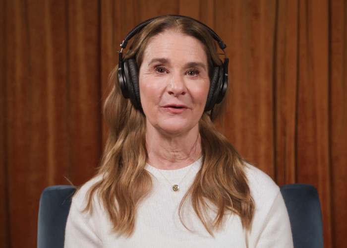 Melinda Gates wearing headphones and white sweater, giving a pointed response about forgiving Bill amid Epstein STD allegations.