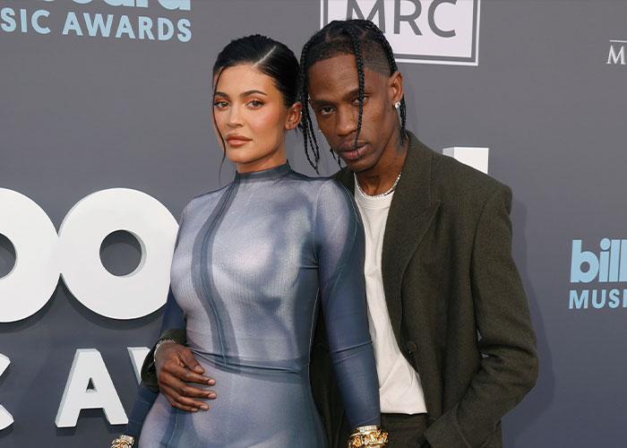 Travis Scott and Kylie Jenner posing together on the red carpet amid controversy over kids&rsquo; birthday party theme.