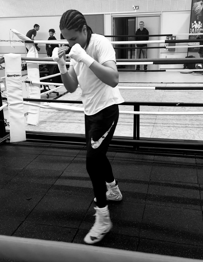 Imane Khelif training in boxing gear at the gym, showing determination amid Y chromosome gene controversy.