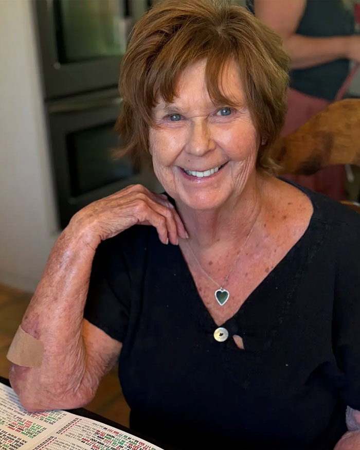 Smiling older woman with short hair sitting at a table, related to Nancy Guthrie disappearance and FBI investigation updates.