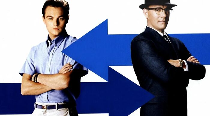 Two iconic movie characters based on real people, standing back-to-back with blue arrows pointing between them.