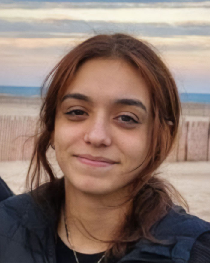 Young woman with brown hair outdoors near a beach, related to missing woman 24 located after final call plea.