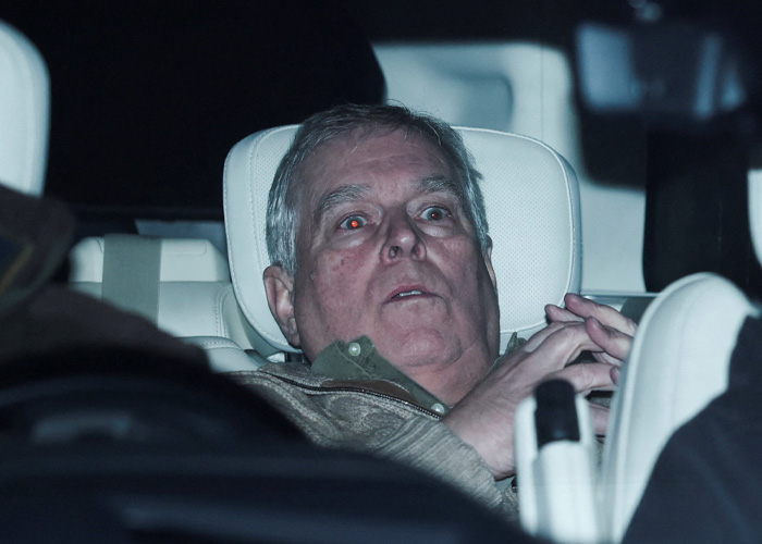 Prince Andrew showing a terrified look sitting in a car after his arrest, captured in the first photos released.