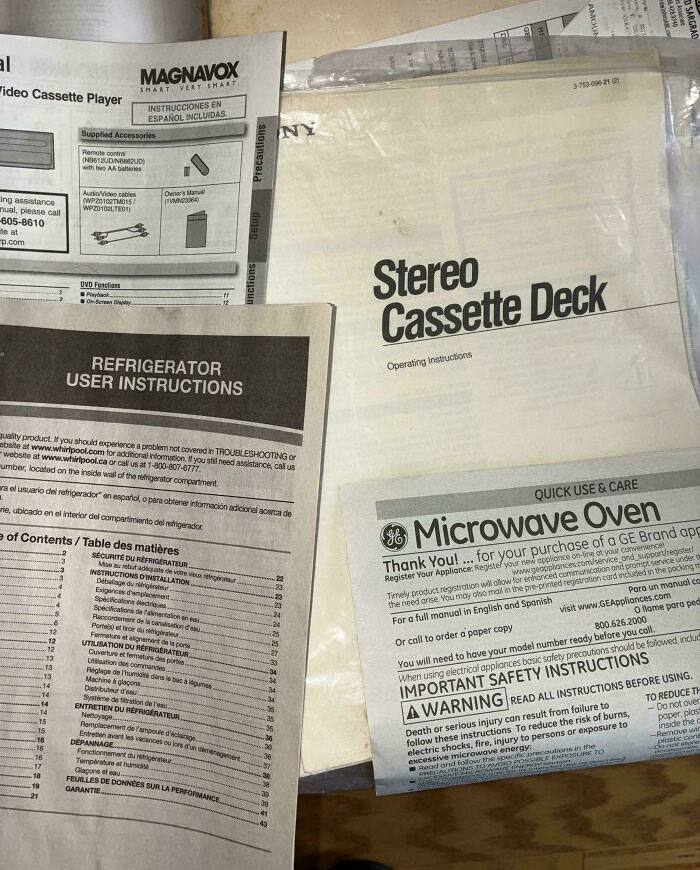 Stack of vintage appliance manuals including stereo cassette deck and microwave oven highlighting nostalgic references.