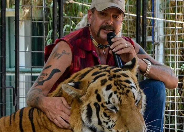 Joe Exotic sitting with a tiger, holding a microphone, highlighting Epstein files post going viral online.