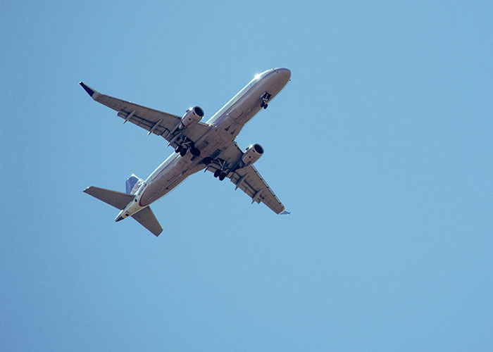Airplane flying in clear blue sky representing freedom and perspective for Today I Messed Up stories feeling better about life.