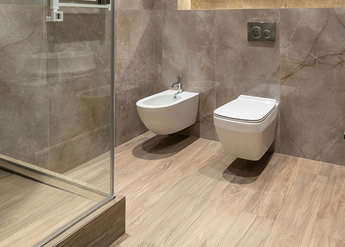 Modern bathroom with wall-mounted toilet and bidet showcasing smart design countries have that just make sense.