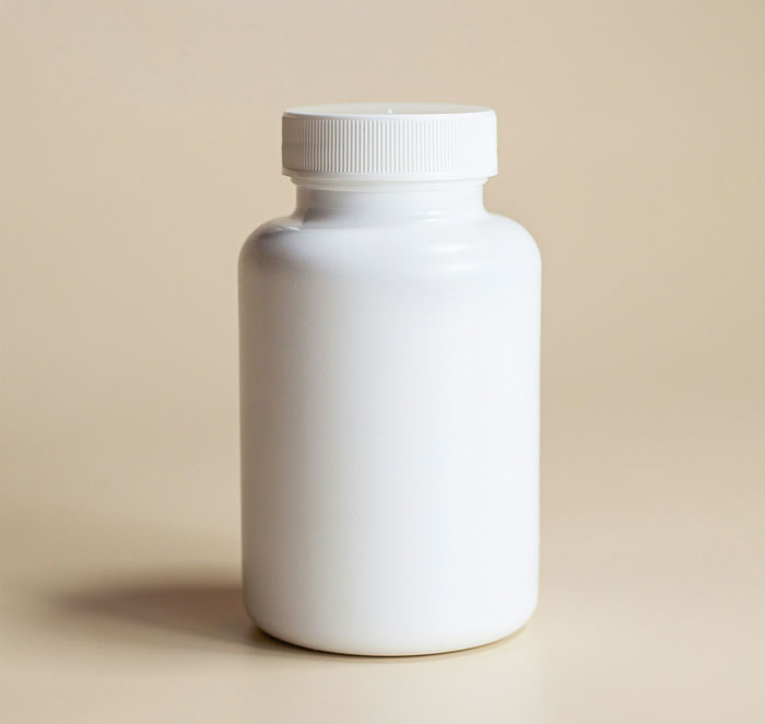 White plastic bottle with a closed cap on a beige surface, illustrating quick fixes that turned out to be genius.