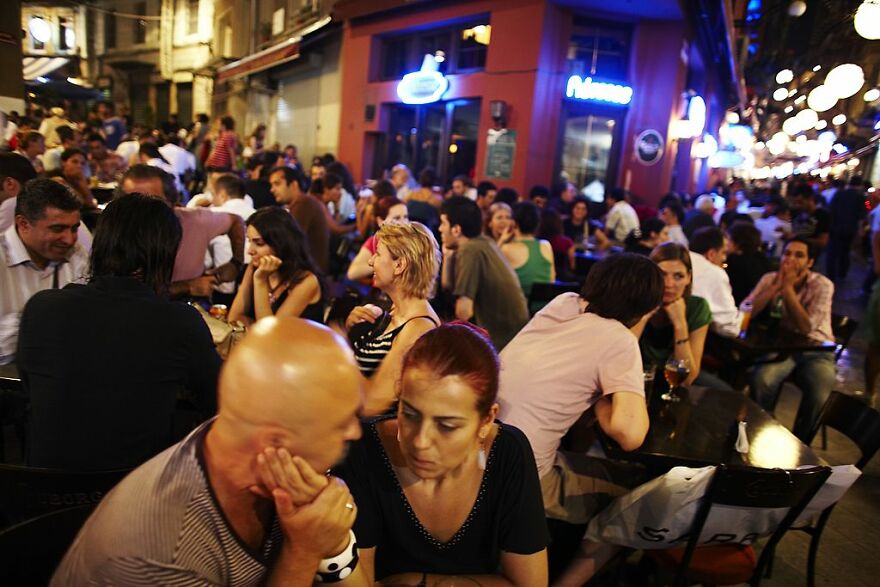 Crowded outdoor nightlife in a vibrant city known for its energetic atmosphere where sleep is optional and the night never ends.