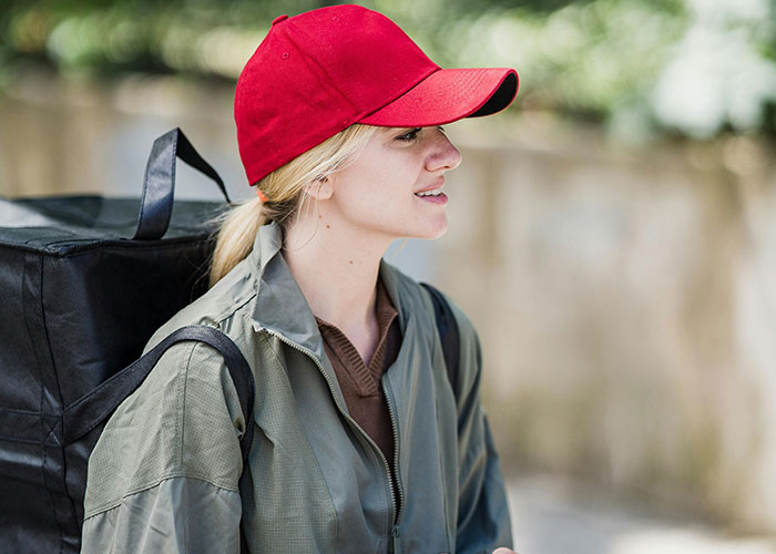 Young woman wearing a red cap and backpack outdoors, reflecting the mood of today I messed up stories.