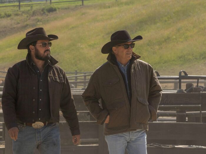 Two men wearing cowboy hats and jackets outdoors on a ranch, related to Yellowstone prequel 1944 release date and plot. Two men wearing cowboy hats and jackets outdoors on a ranch, related to Yellowstone prequel 1944 release date and plot.