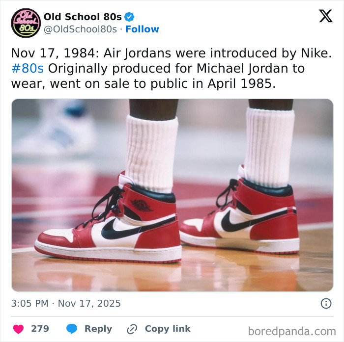 Close-up of red and white Air Jordan sneakers on a basketball court, celebrating iconic 80s style and nostalgia.