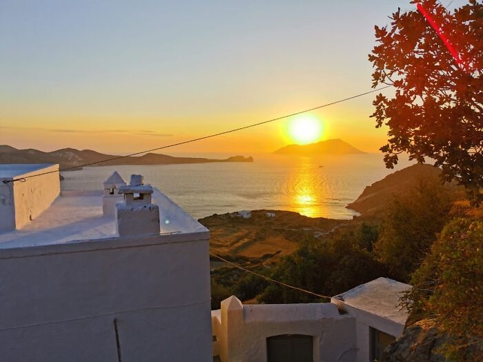 Sunset view over the sea with white buildings, reflecting the feeling of living out of a suitcase for years. Sunset view over the sea with white buildings, reflecting the feeling of living out of a suitcase for years.