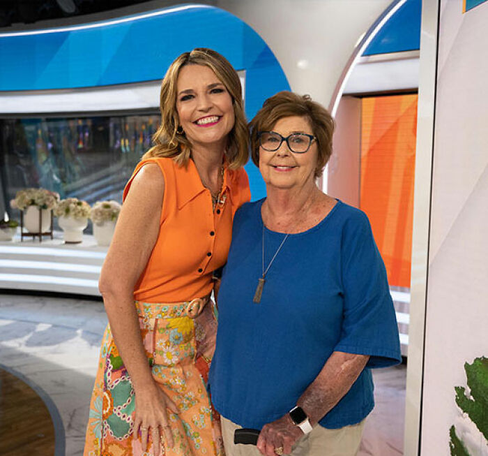 Two women smiling together indoors, related to police chilling new theory after Savannah Guthrie's mom vanished.