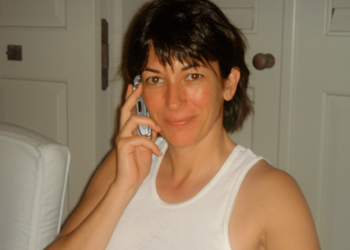 Ghislaine Maxwell in casual white tank top talking on phone, linked to internet users questioning prison appearance theory.