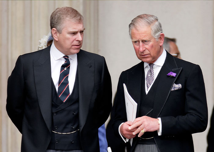 Prince Andrew and King Charles in formal attire, engaged in a serious conversation at a public event. Prince Andrew and King Charles in formal attire, engaged in a serious conversation at a public event.