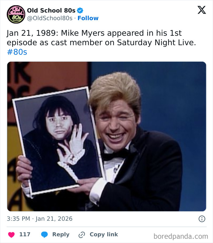 Man in tuxedo holding framed photo of Mike Myers in dark wig, representing Over 300K people following 80s nostalgia page.